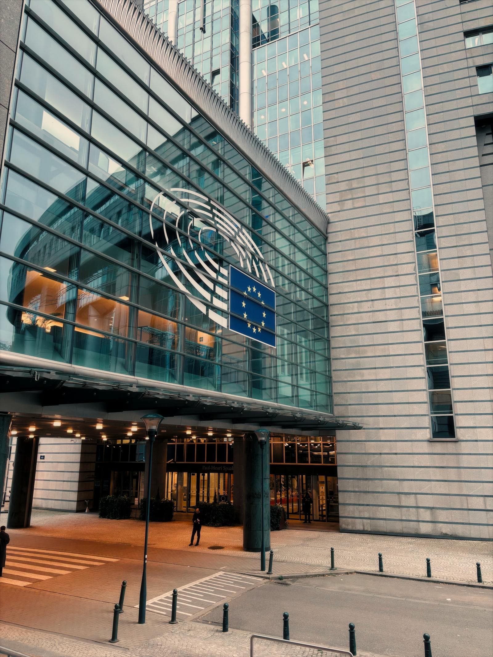The European Parliament building in Brussels with the EU flag.